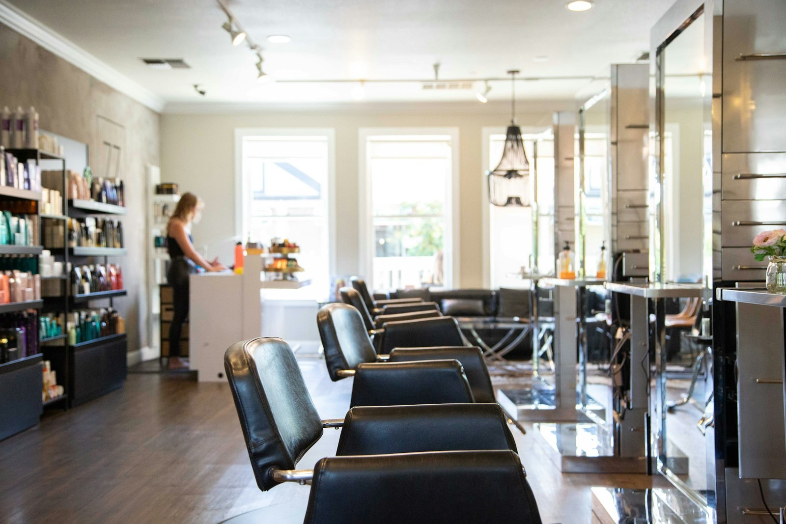 Salon haircare shelves and styling stations showcasing professional colour-care and toning selections