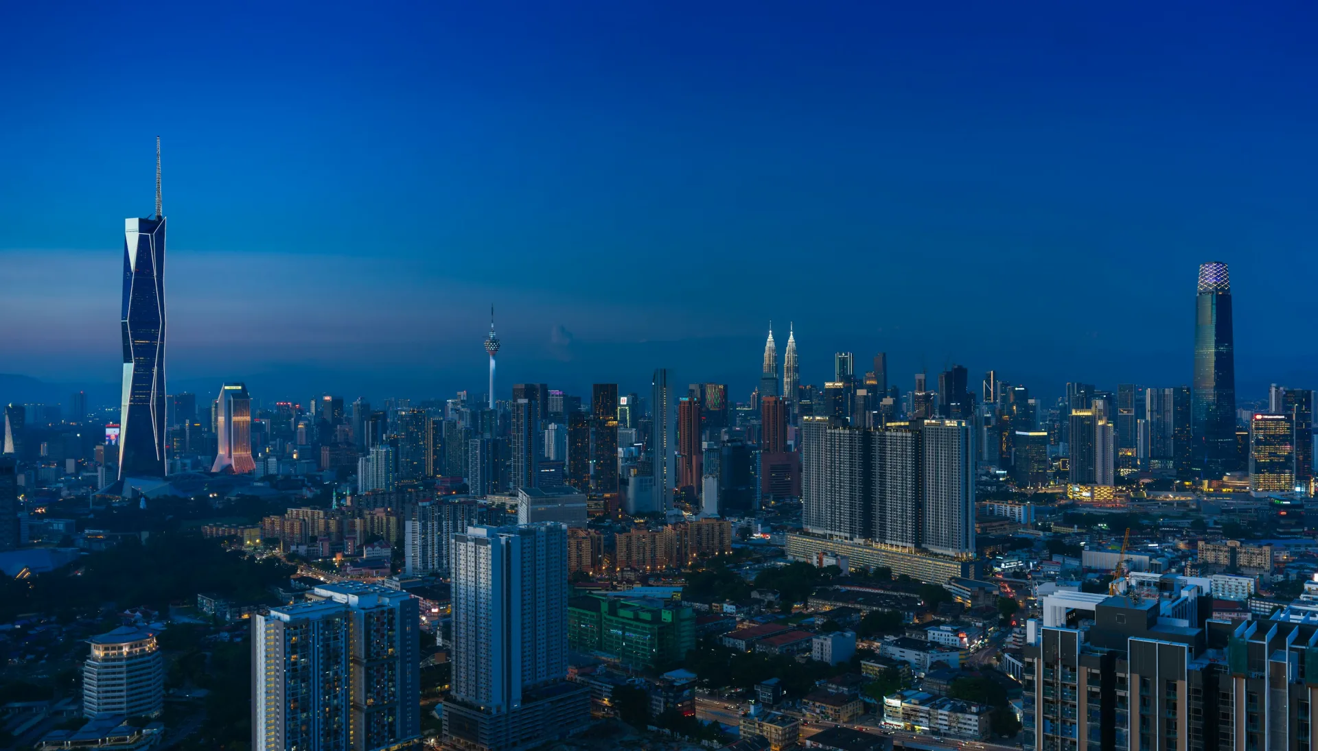 Kuala Lumpur skyline at blue hour with Merdeka 118, KL Tower and the Petronas Towers